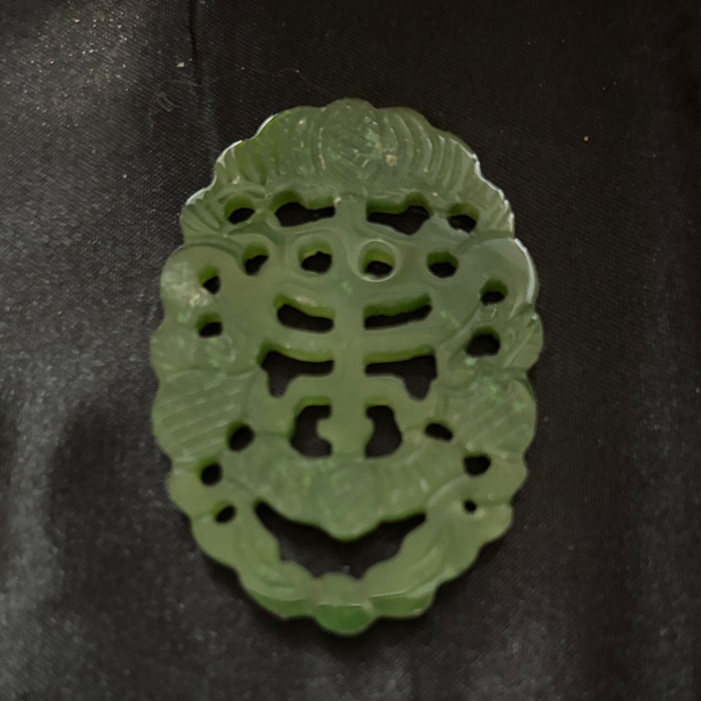 Carved Green Jade Pendant - Intricate Filigree Design